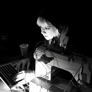 A woman working on a computer in the dark